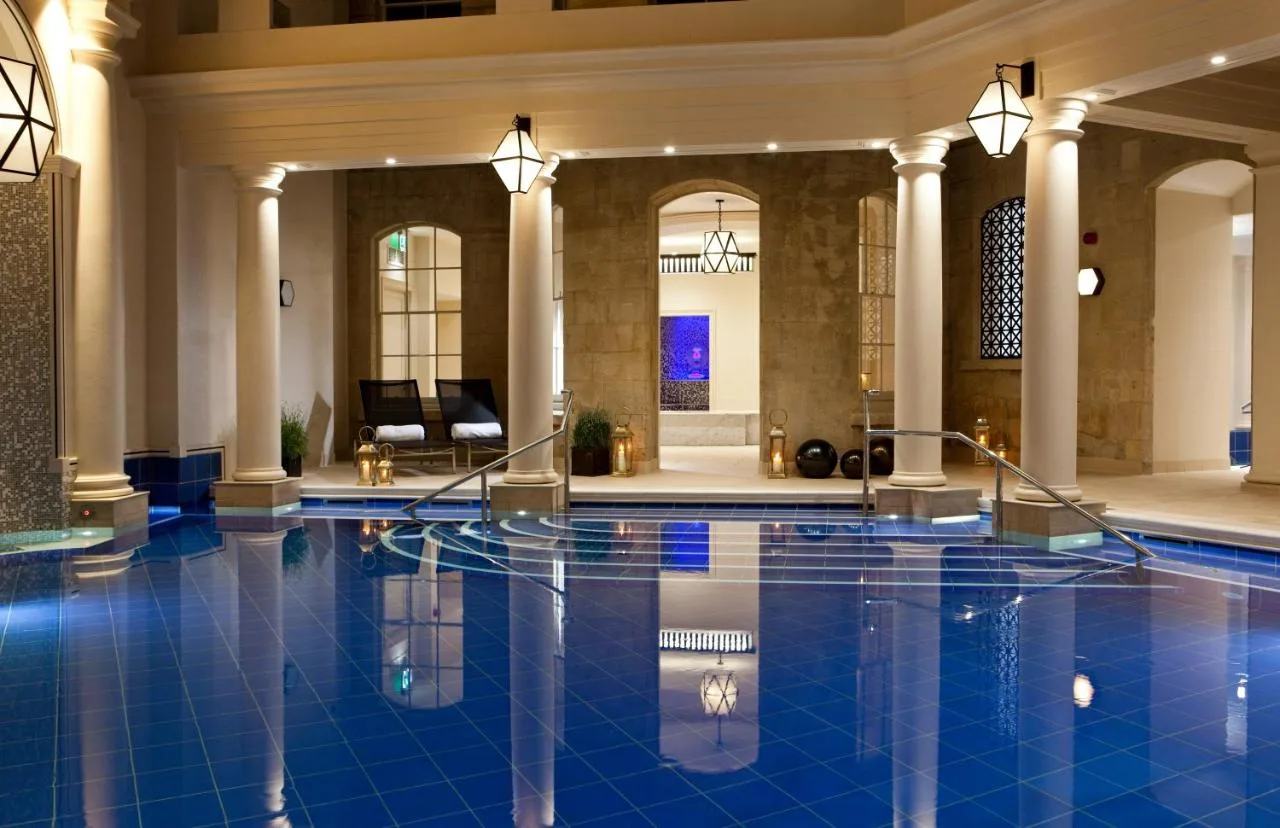 a swimming pool in a building with a lobby at The Gainsborough Bath Spa in Bath